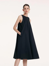 a lady in black a-line midi vest dress
